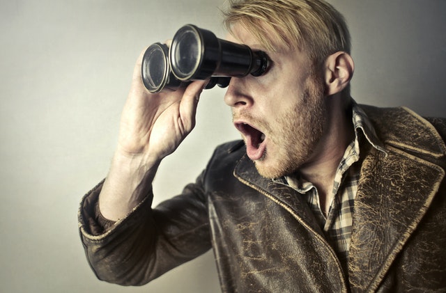 a man looking through binoculars